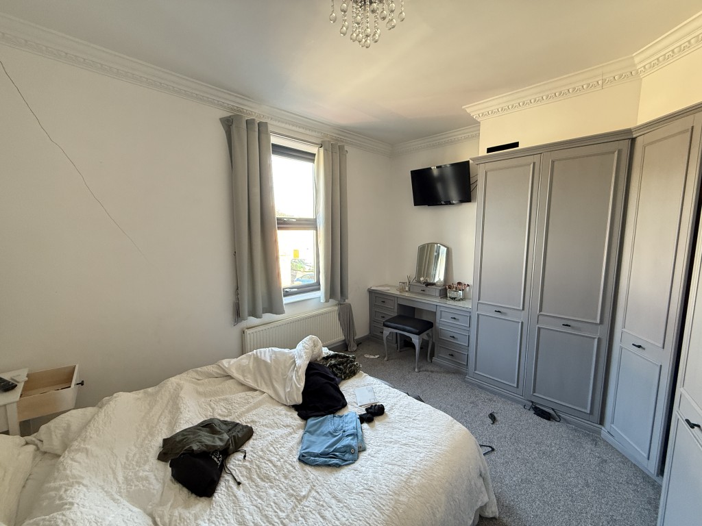 Lot: 35 - THREE-BEDROOM HOUSE WITH STRUCTURAL DAMAGE - Bedroom one with fitted wardrobes